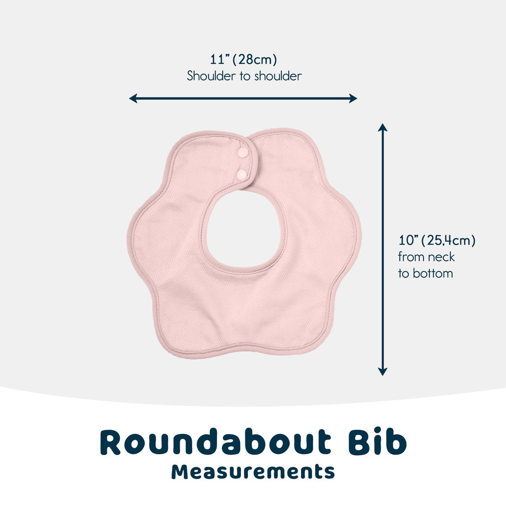 Tiny Twinkle Roundabout worn by baby to illustrate stylish teething bib in pink.