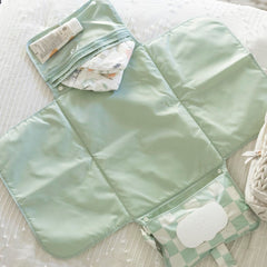 Tiny Twinkle changing pad clipped to stroller with snap-loop handle