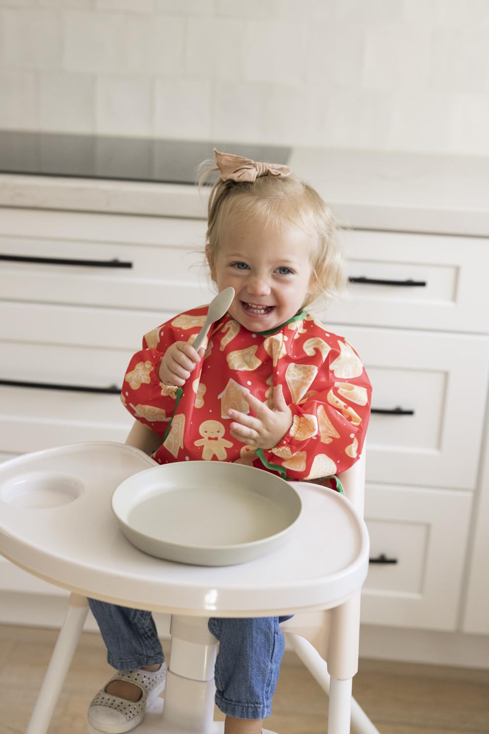 Tiny Twinkle waterproof bib showing full-body coverage during meals.