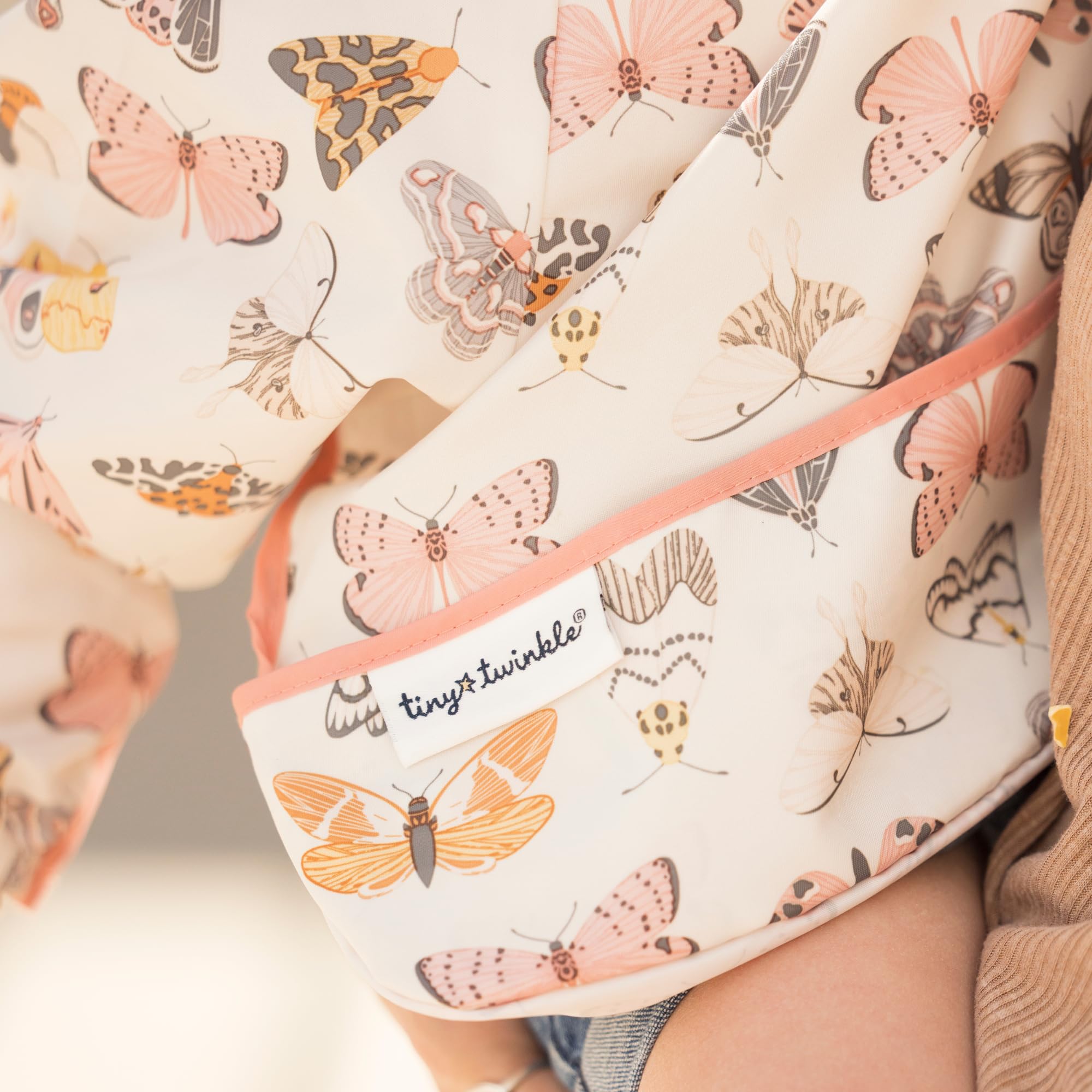 Tiny Twinkle waterproof-sleeve bib closeup highlights quick-dry, mess-friendly fabric.