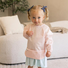 Tiny Twinkle waterproof-smock-bib in action keeping outfits clean during meals.