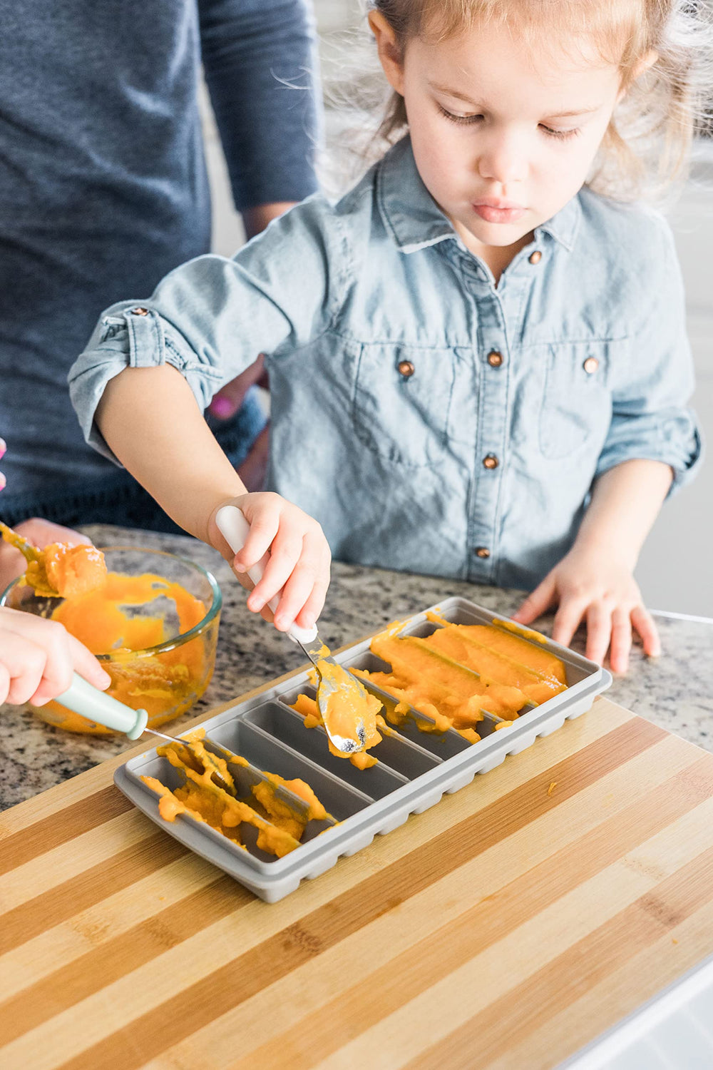 Tiny Tot Innovations two-containers-with-lids illustrate bundled storage for mess-free trips.