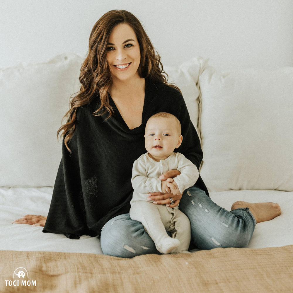 Toci Mom car-seat cover acts as privacy shield during outdoor outings.