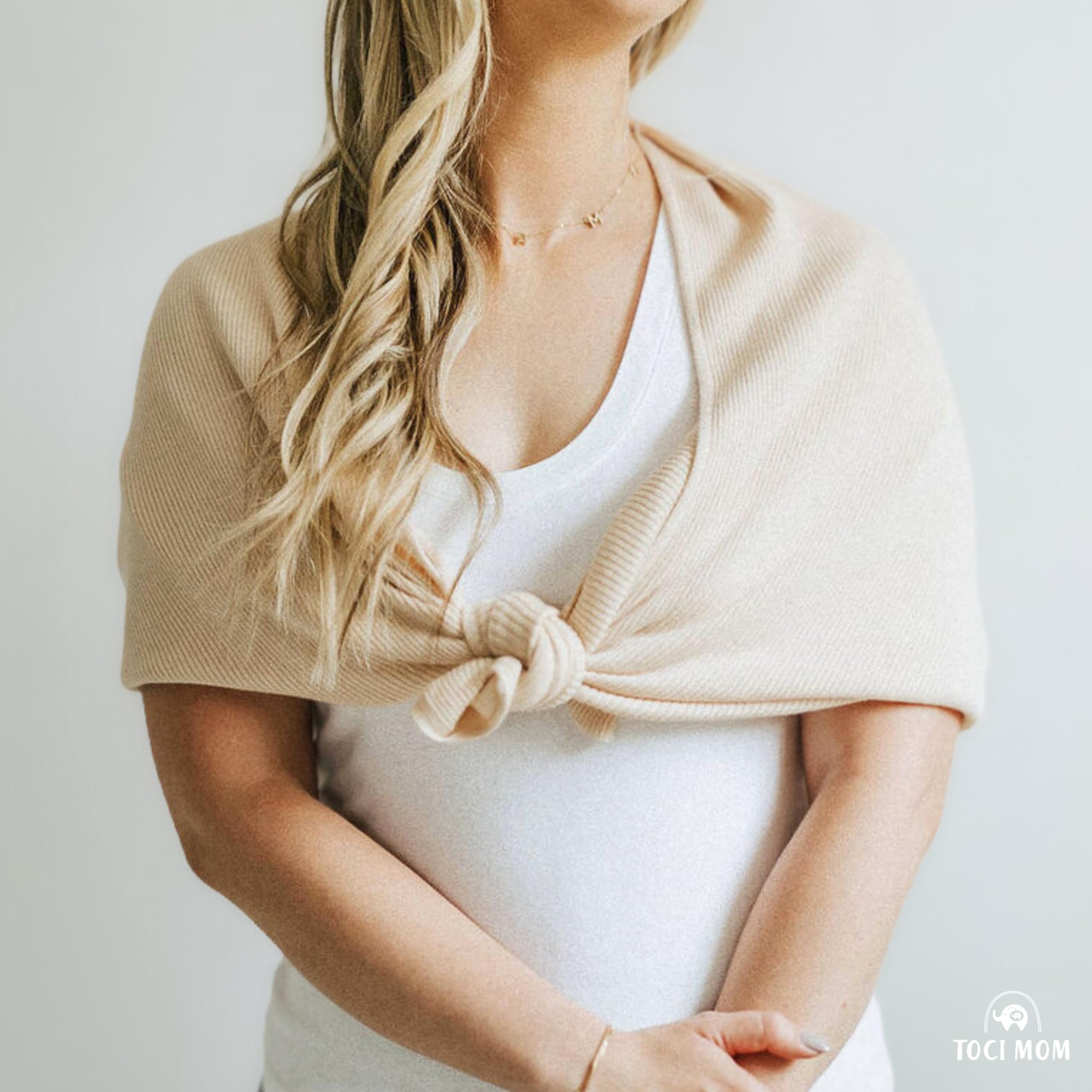 Toci Mom lightweight nursing cover folded inside a diaper bag for travel.