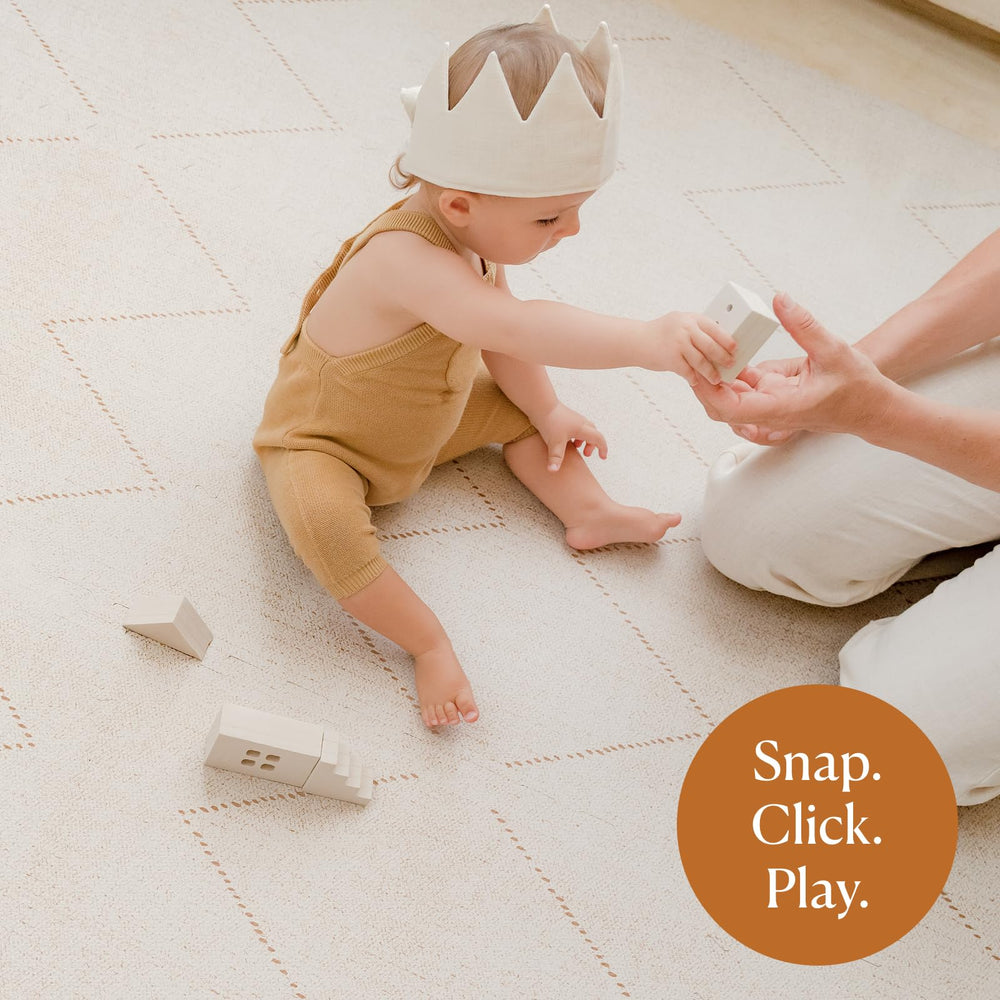 Toddlekind Playmat off-white being wiped clean with a damp cloth for quick cleanup.