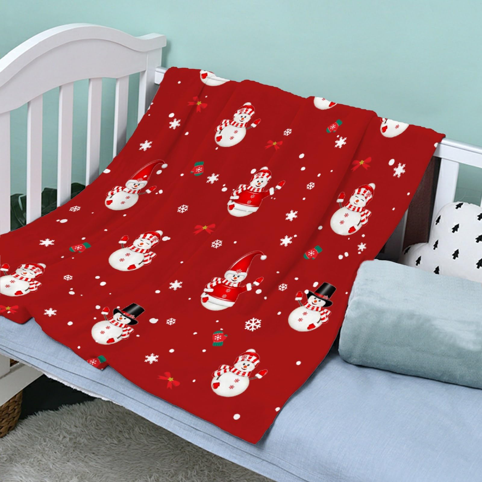 Todeyya Christmas Snowman blanket in crib demonstrates gentle warmth for infants.