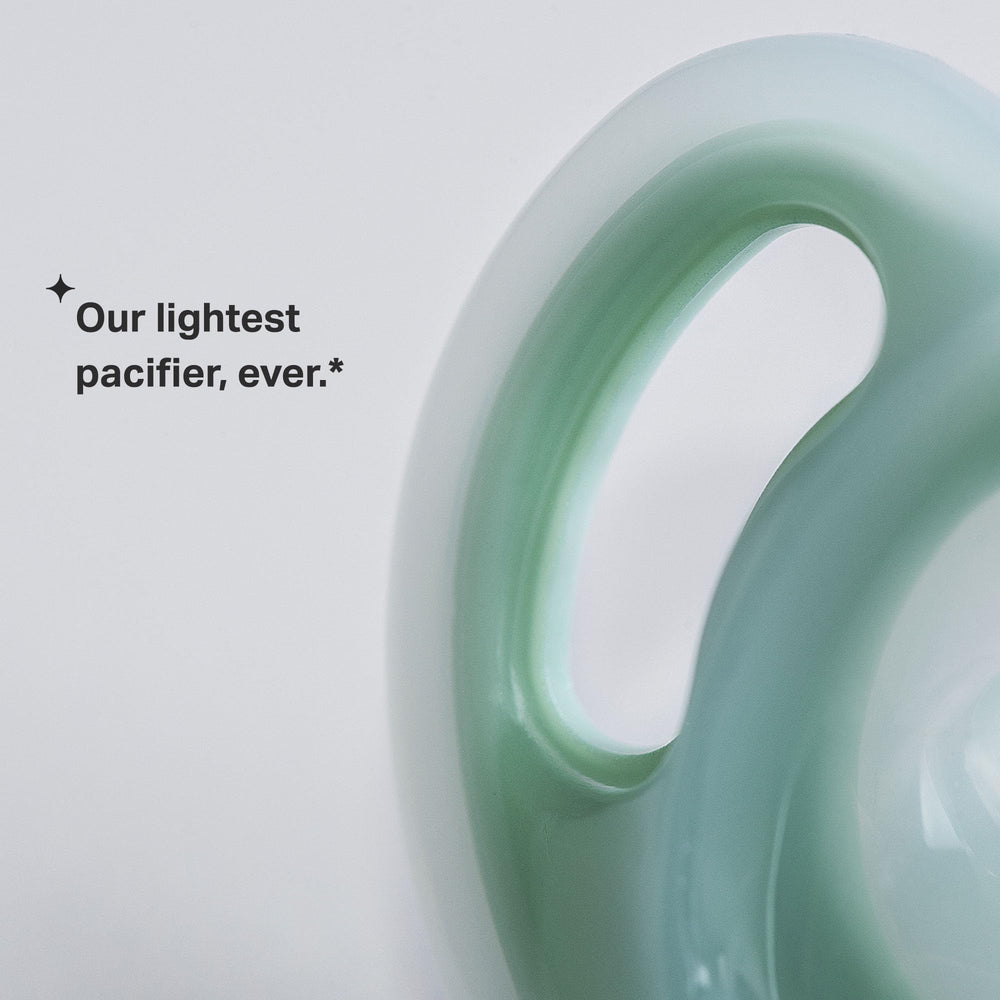 Tommee Tippee Ultra-Light Pacifier curved shield provides gentle fit between nose and chin.
