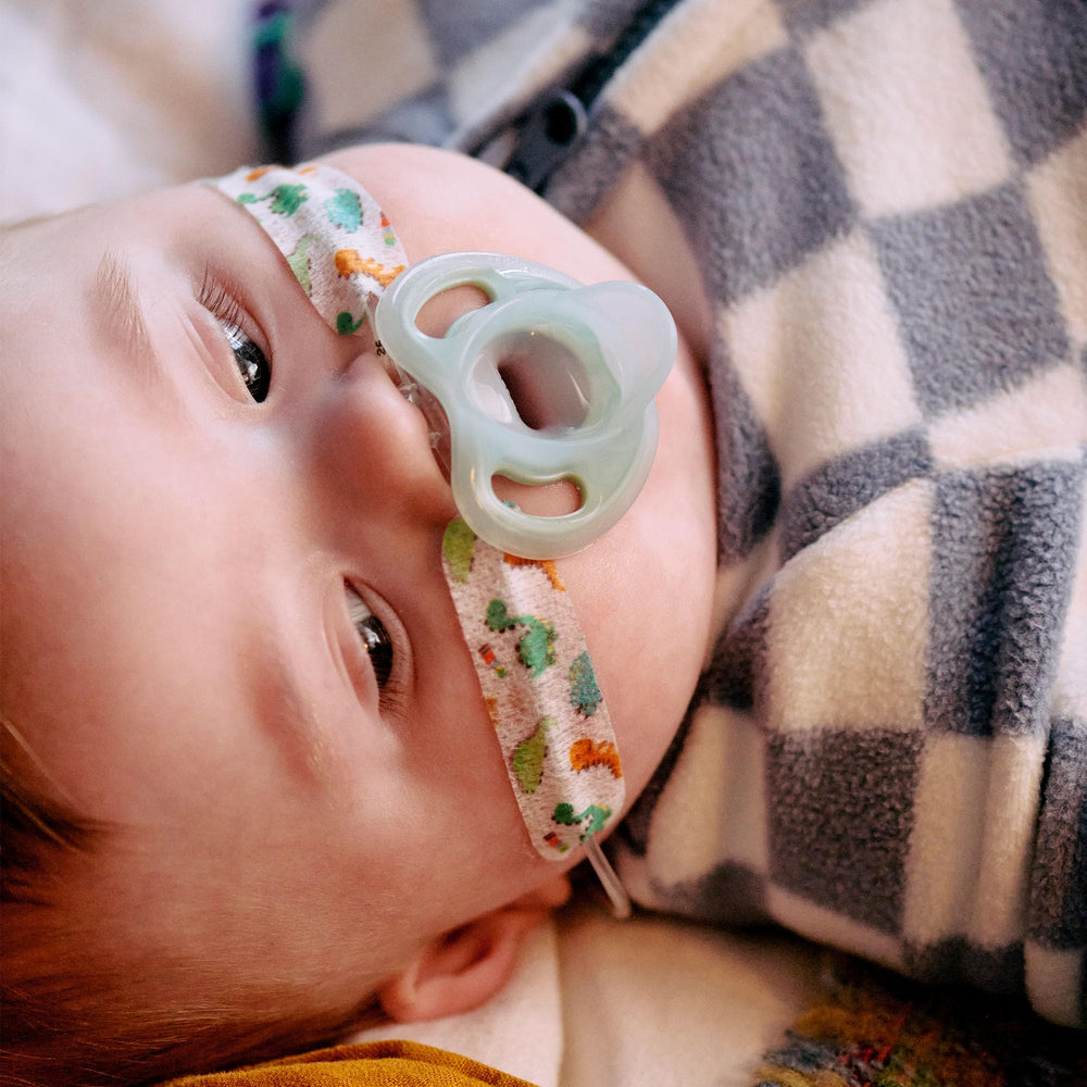 Tommee Tippee Ultra-Light Pacifier mouth close-up highlights lightweight comfort for baby.