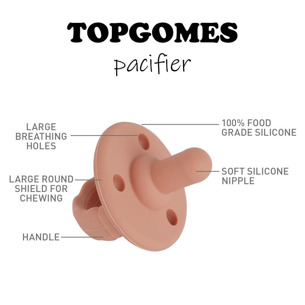 TOPGOMES baby using Christmas Soother pacifier during quiet playtime.