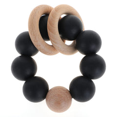 TopGomes silicone baby teether with beech wood closeup, soothing gums and safe materials.