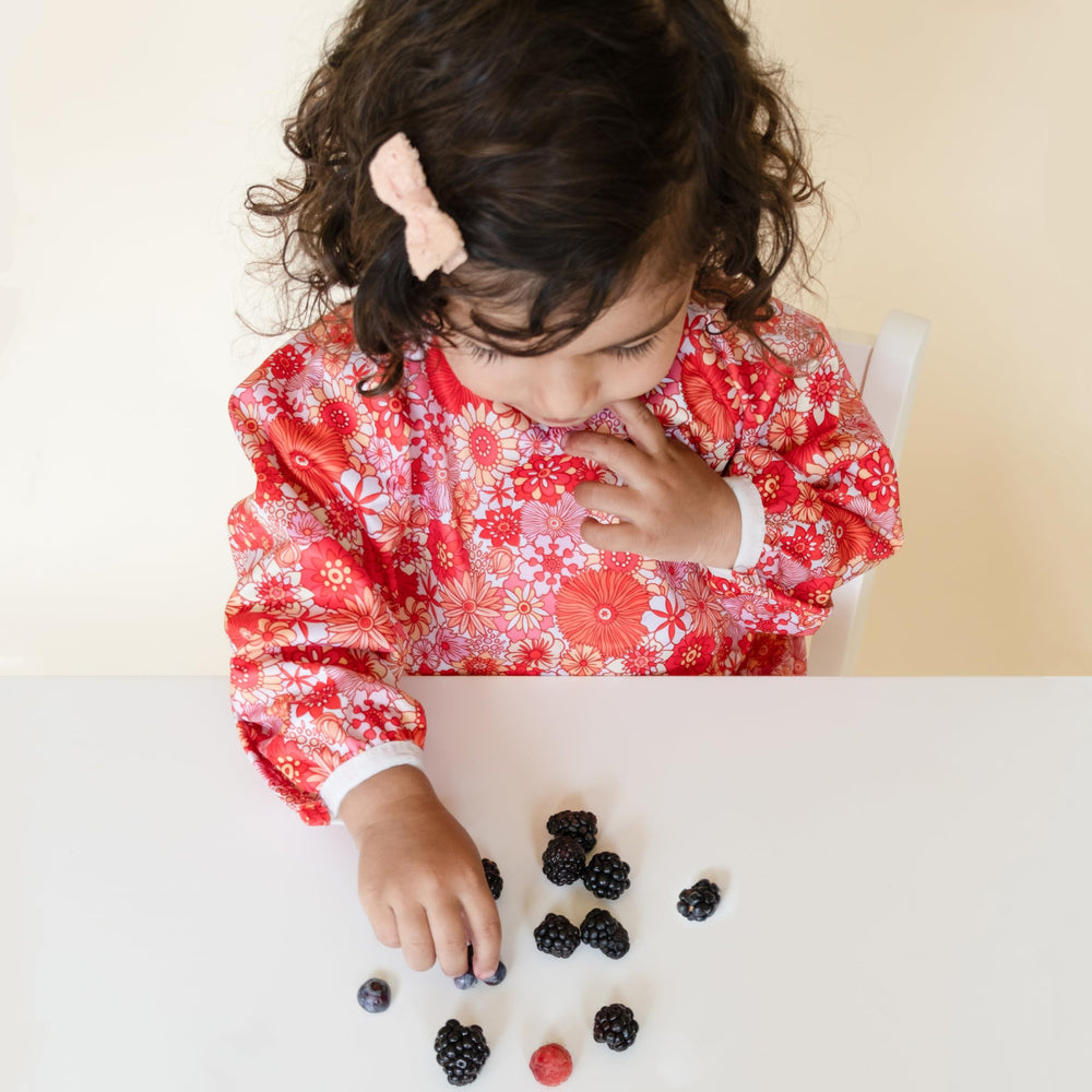 Torange baby smock bib adjustable neckline close-up shows comfy fit for growing toddlers.