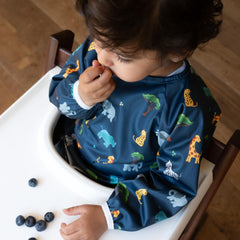 Torange baby smock bib pocket closeup highlighting built-in food catcher