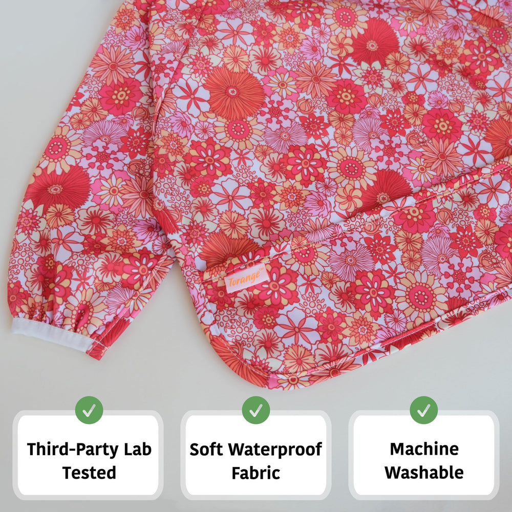 Torange smock bib elastic cuffs close-up demonstrates secure tug-proof fit.