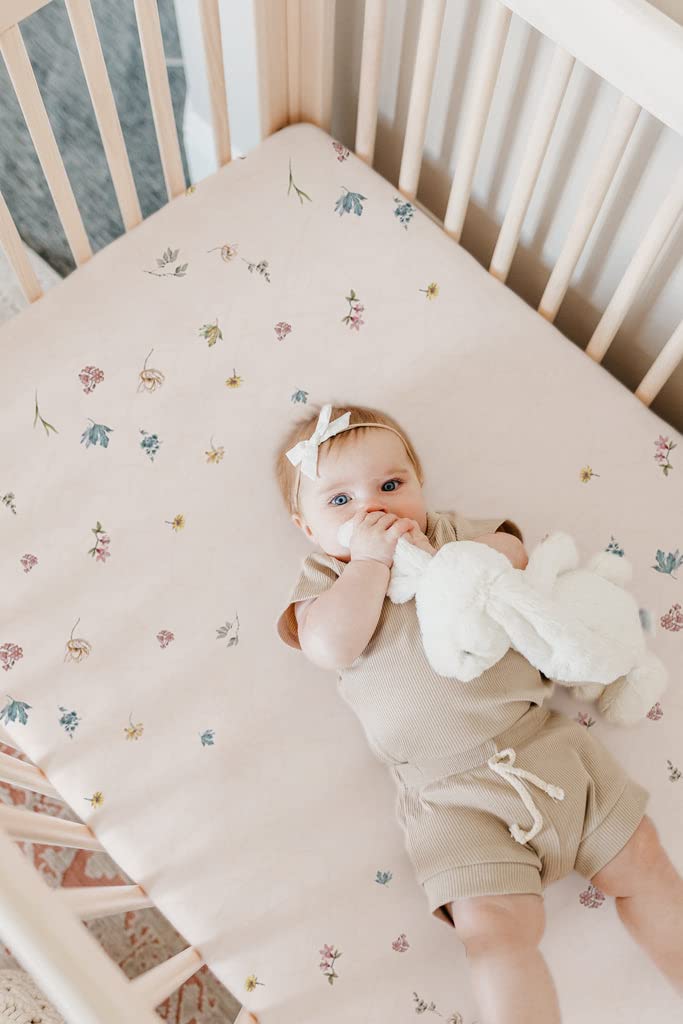 TotAha 28x52x9 inch sheet on mattress shows snug fit for standard cribs.