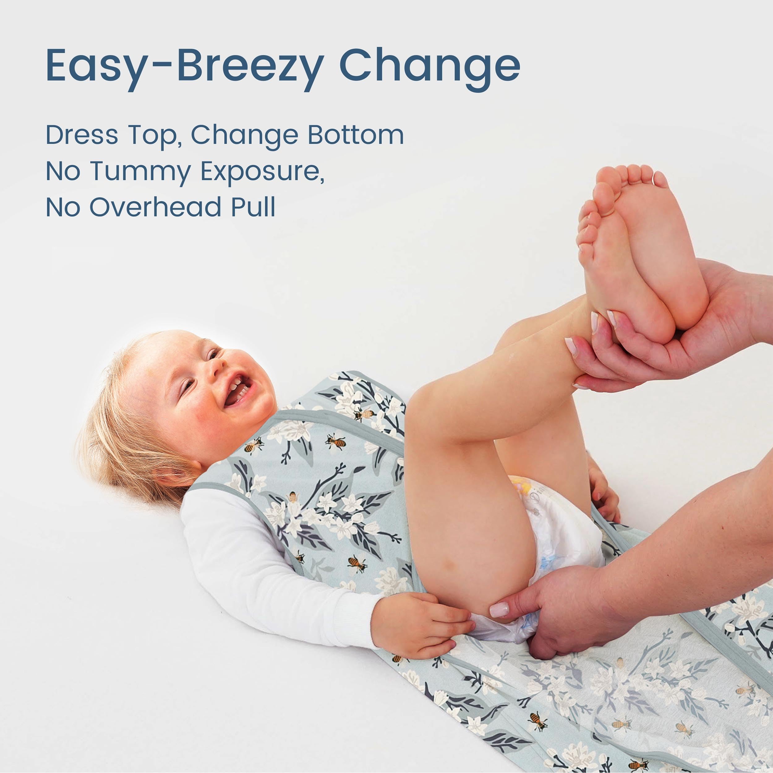 TOTBASIC Bee Floral sleep sack shown in bed supports safe hip movement.