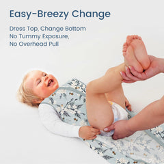 TOTBASIC Bee Floral sleep sack shown in bed supports safe hip movement.