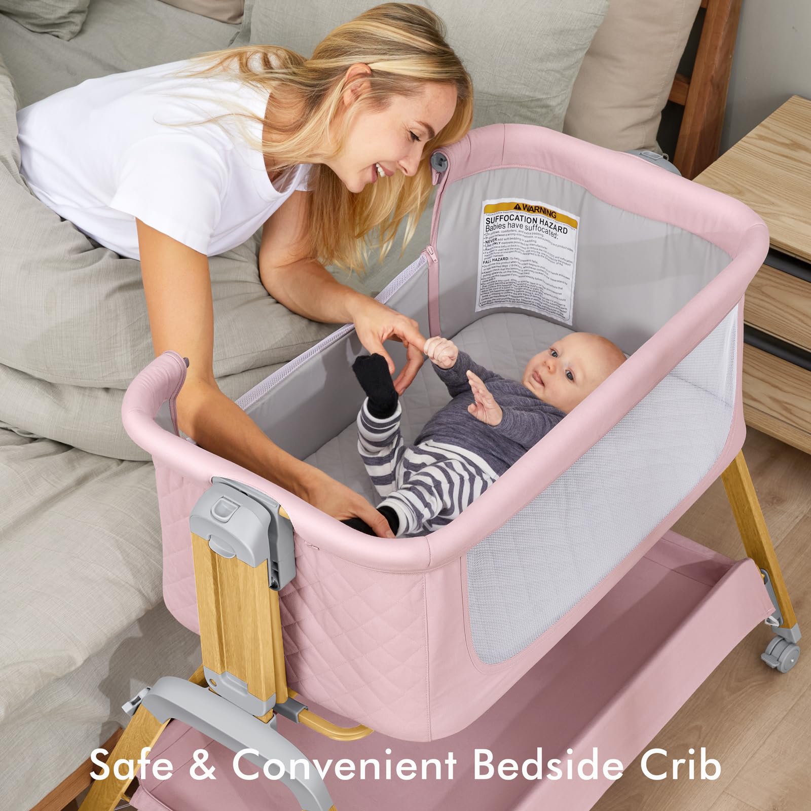 TotRun bassinet bedside sleeper pink attached to bed demonstrates convenient nighttime access