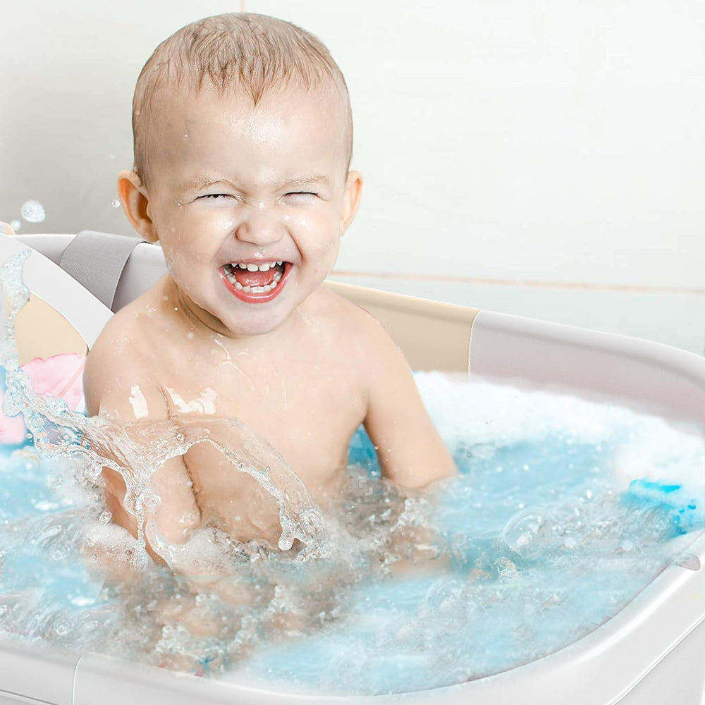 TPN collapsible baby bathtub beige color in use for newborn to toddler baths.