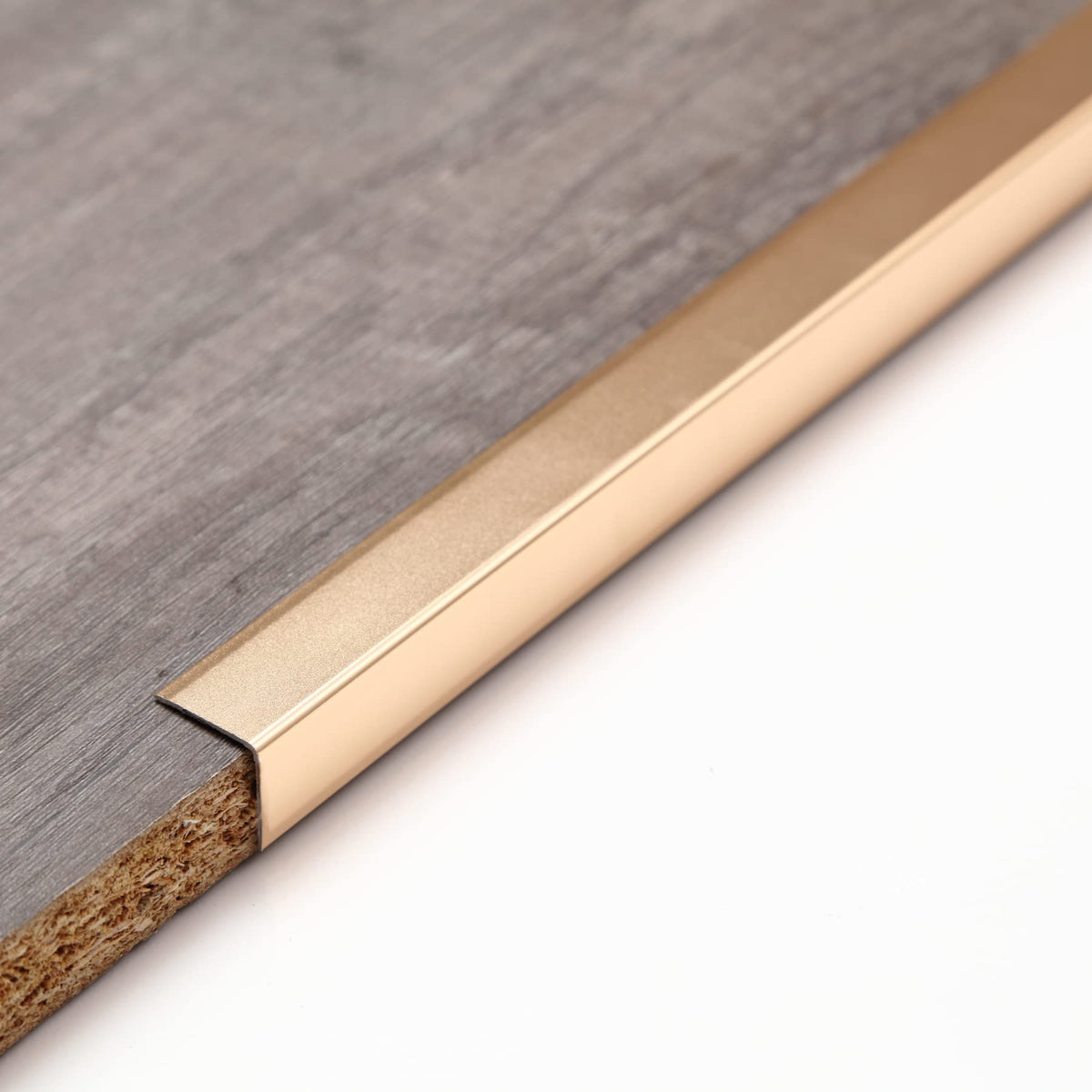 Trimold aluminum corner guard close-up with mirror finish and edge protection.