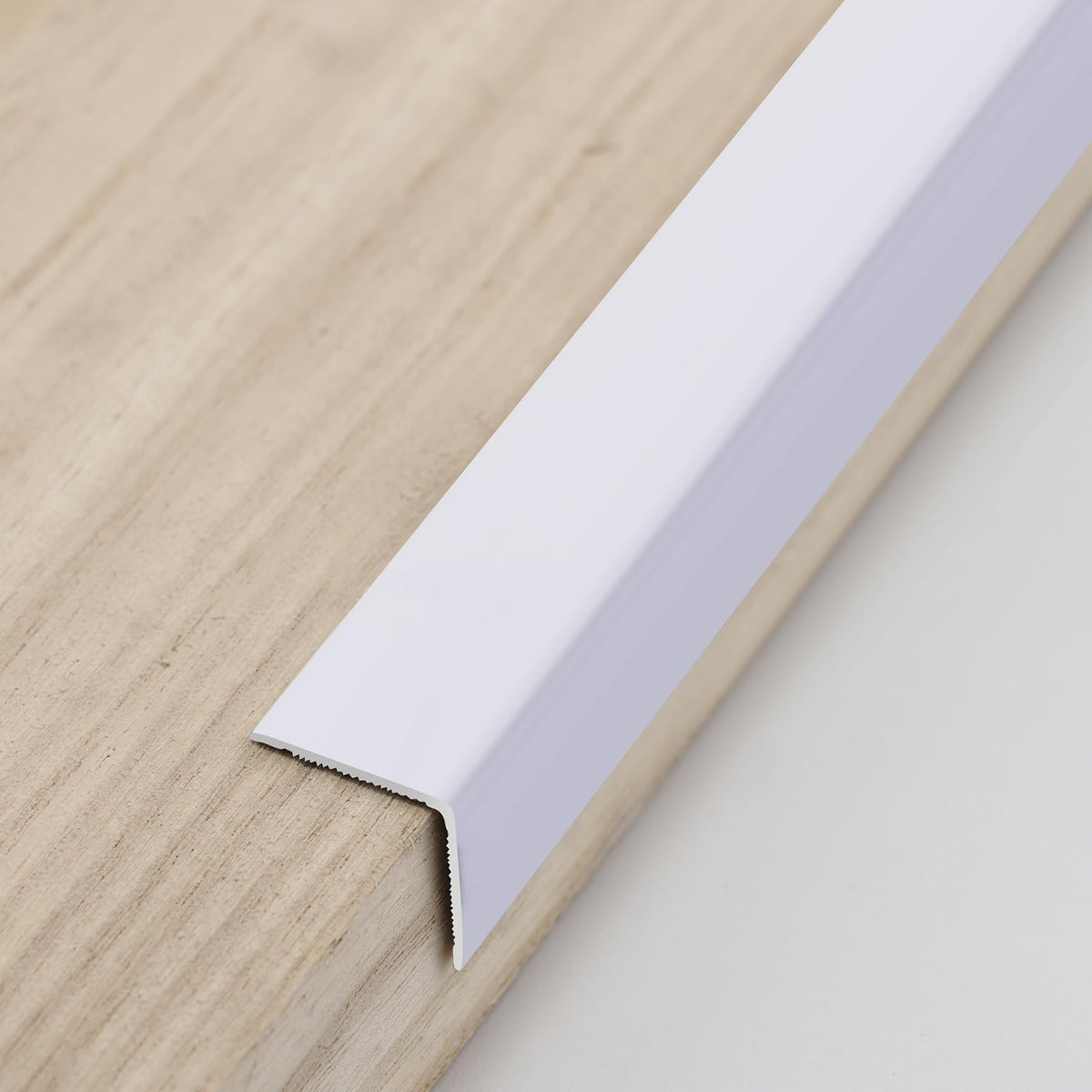 Trimold aluminum peel-and-stick L-molding corner guard on wall corner provides durable protection.