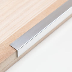 Trimold aluminum peel-and-stick L-molding guard in a 3-pack for durable wall corner protection.