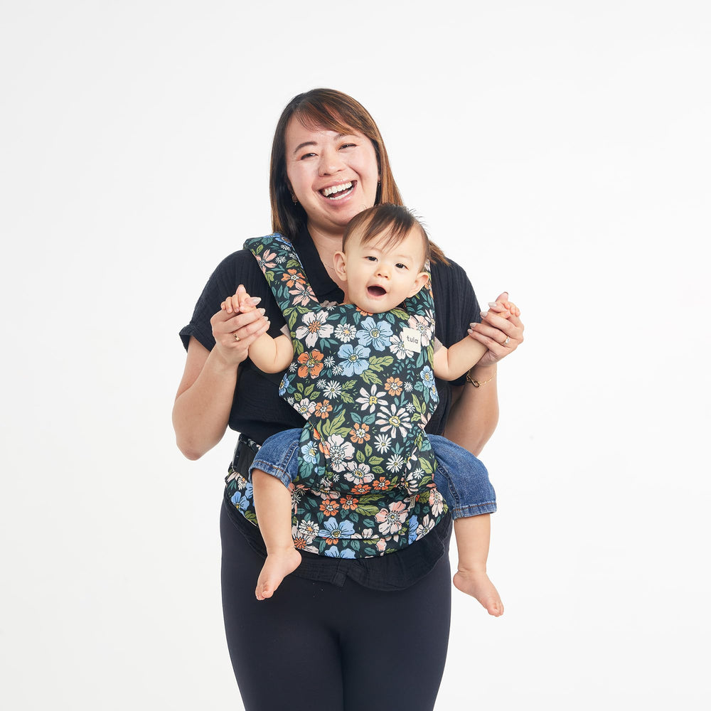 Tula Explore neck pillow and removable hood for sun protection.