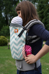 Tula infant insert gray with integrated harness demonstrates secure setup for safe infant carriage