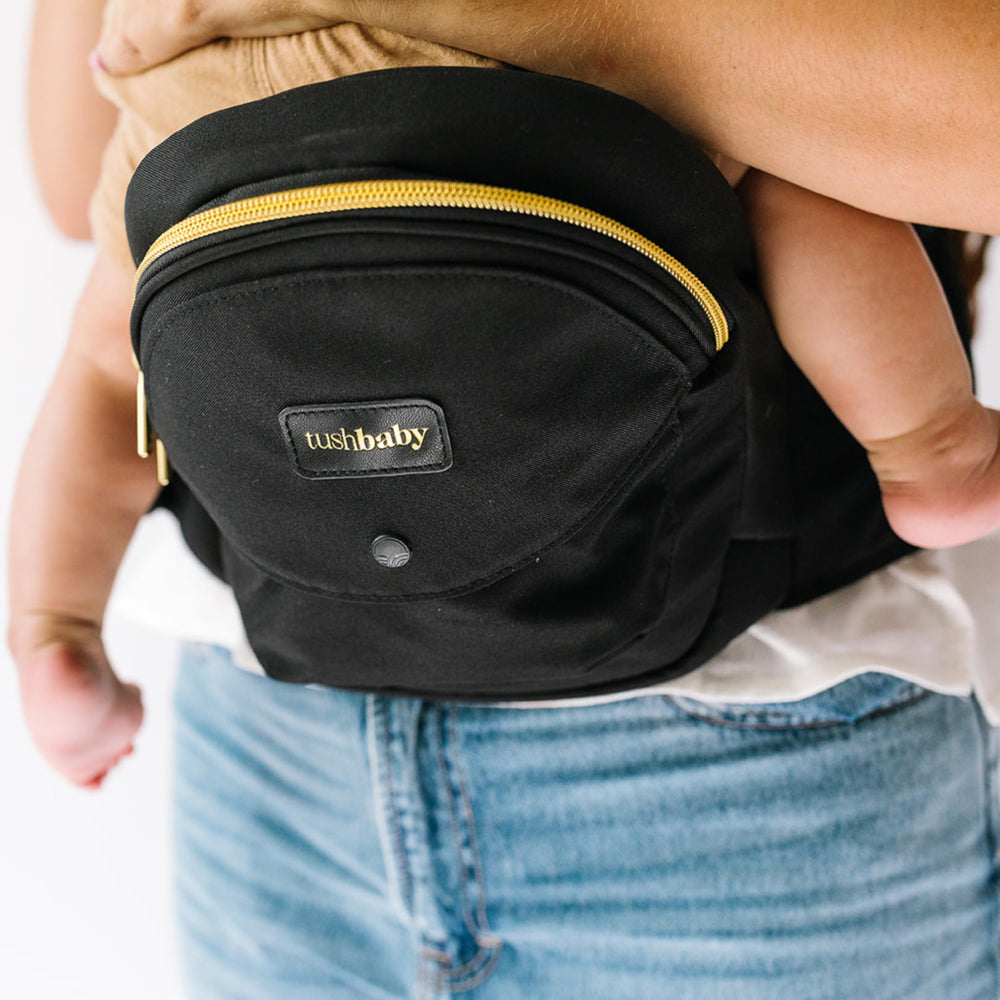 TushBaby bottle-holder closeup highlights discreet feeding support and bottle access.