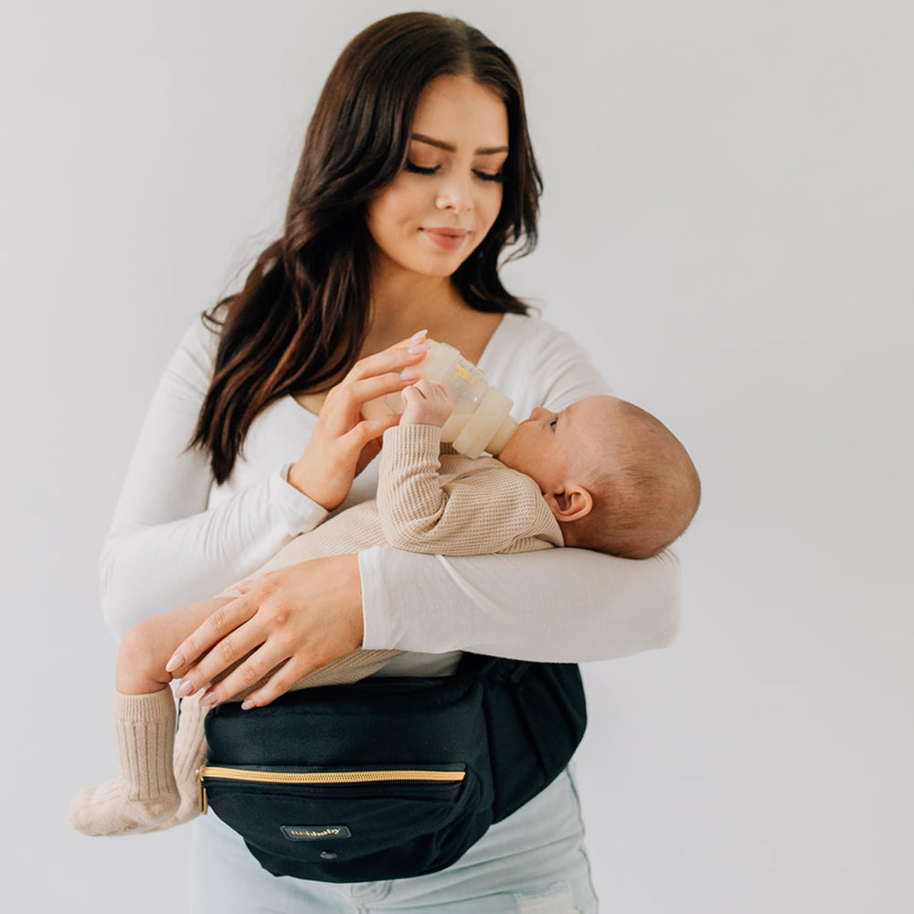 TushBaby face-to-face carry in use shows baby facing parent and attentive interaction.