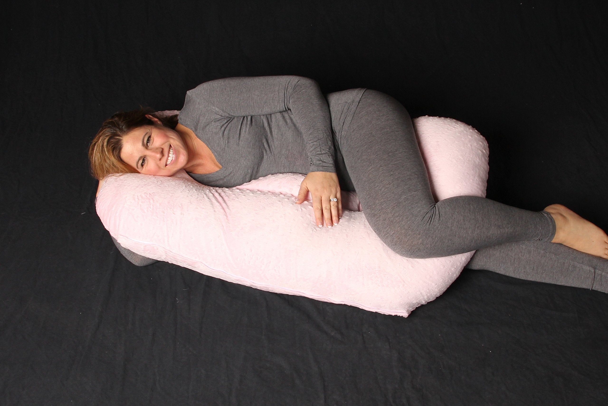 Twin Z pillow with pink cover in use for twin infants comfort.