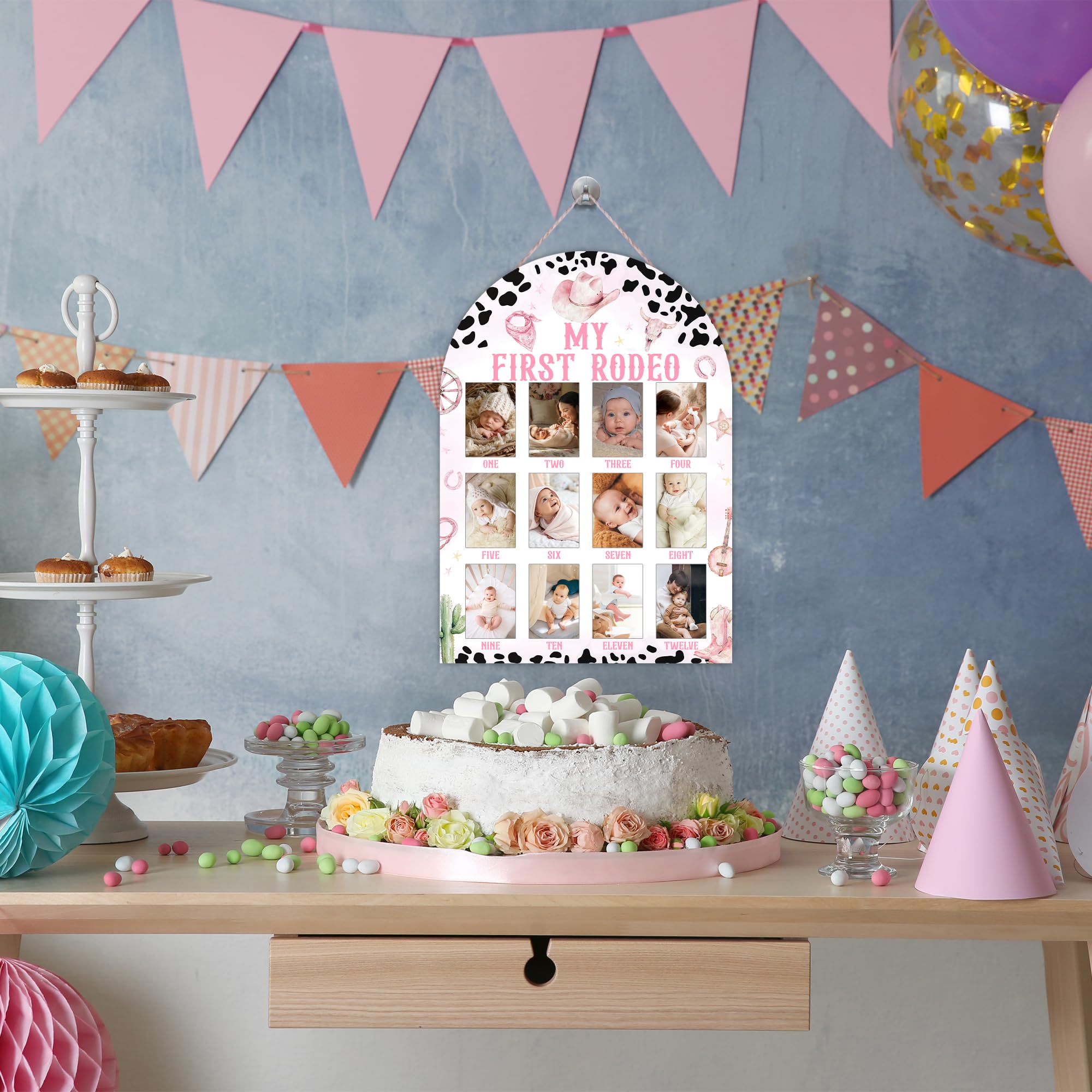 UIBOVA My First Rodeo Photo Board hanging setup with rope and hooks for nursery display.