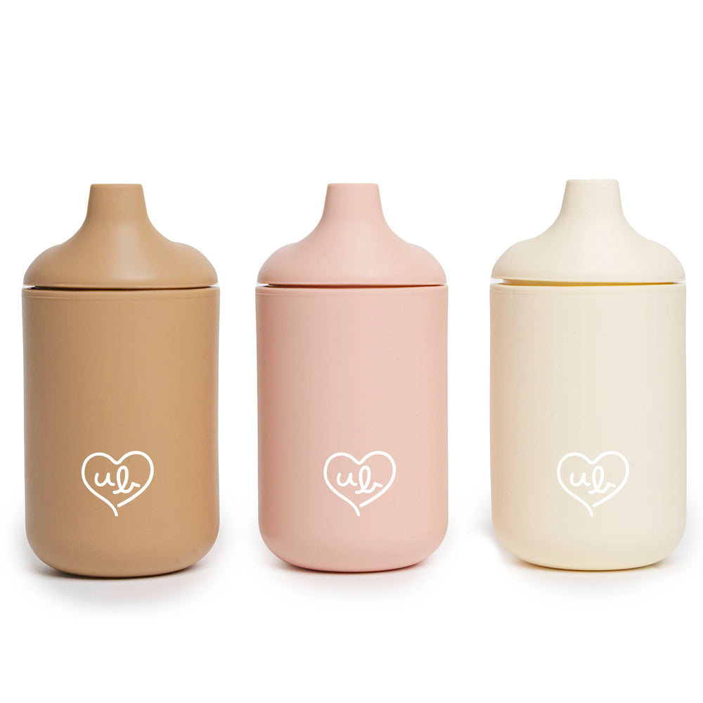 Ullabelle baby silicone cups with beige lid spill-proof on-the-go use.