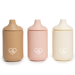 Ullabelle baby silicone cups with beige lid spill-proof on-the-go use.
