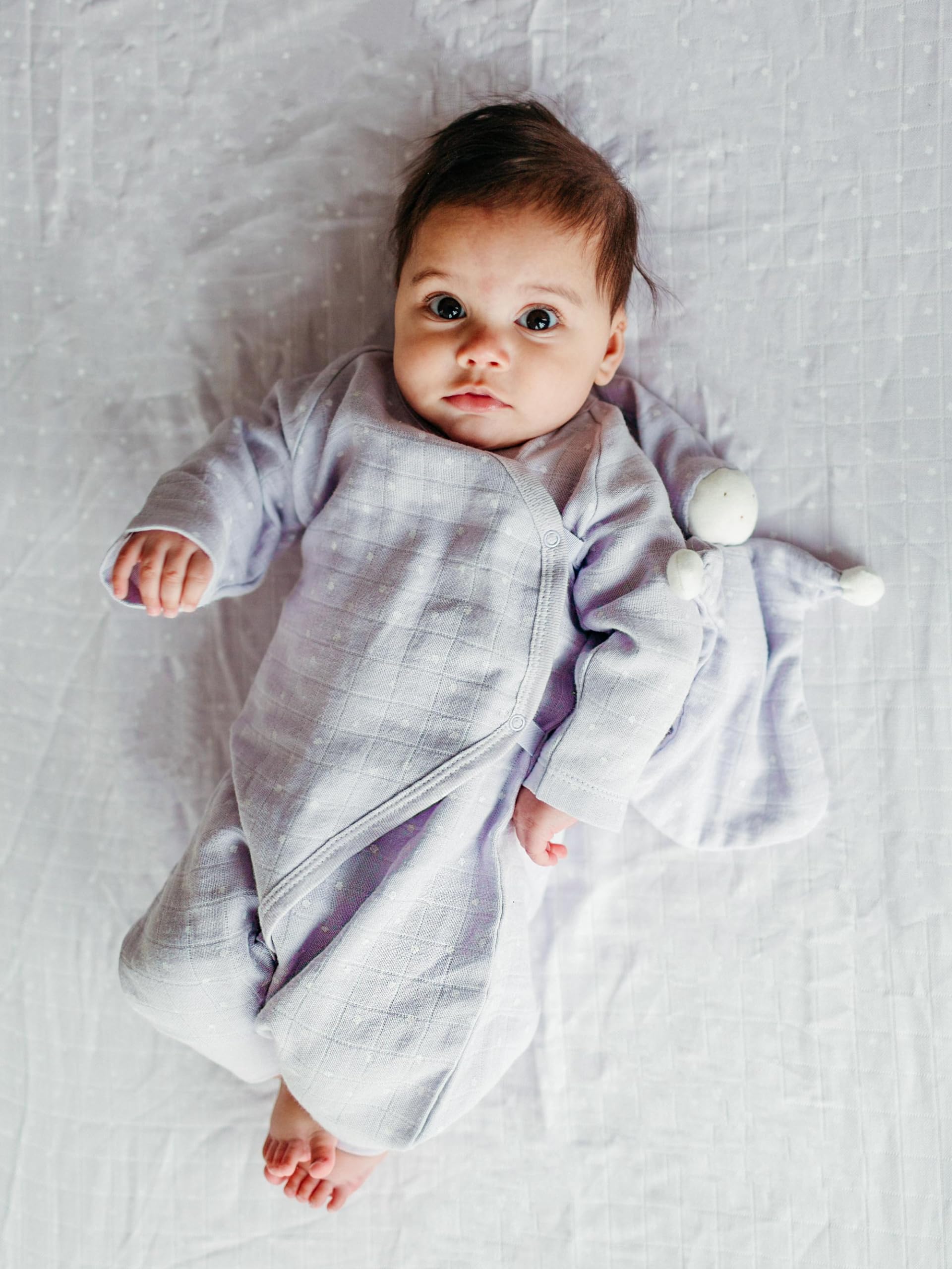 Under The Nile Muslin Sleeping Lovey knotted-hands closeup highlights easy-grasp design for soothing cuddles