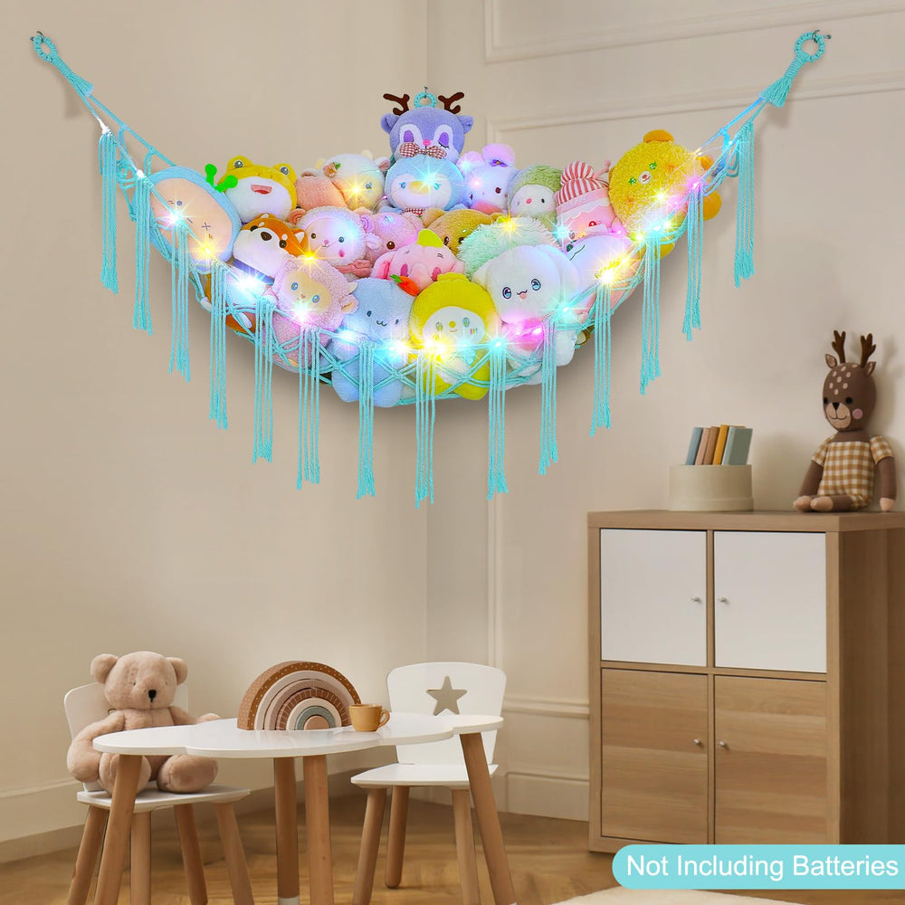 Unicorn Castle boho hammock decor doubles as plush toy storage in a nursery.