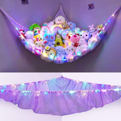 Unicorn Castle LED-lit hammock holds plush toys and adds cozy glow.