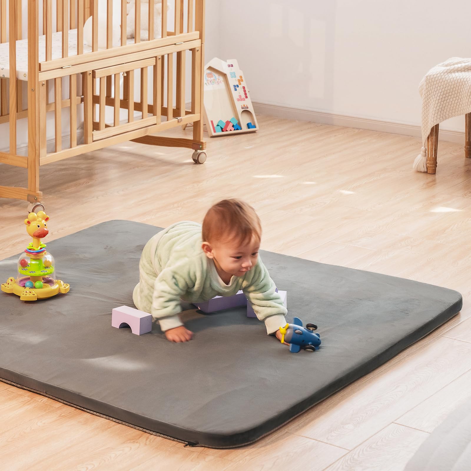 Uniency baby play mat front view in grey, thick foam supports tummy time.