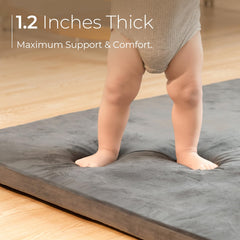Uniency baby play mat removable cover shown being machine washed for easy cleaning.