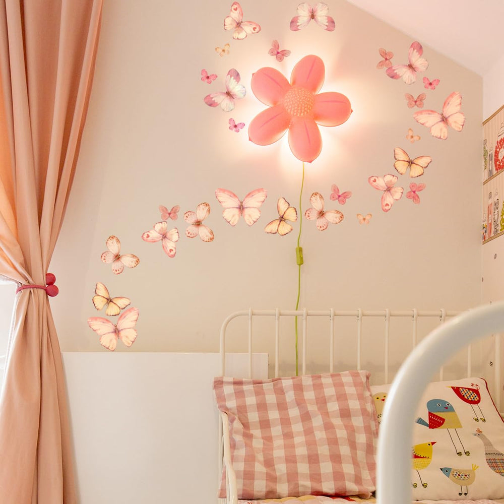 Unonede Nursery room decor with pink butterfly stickers adding whimsy.