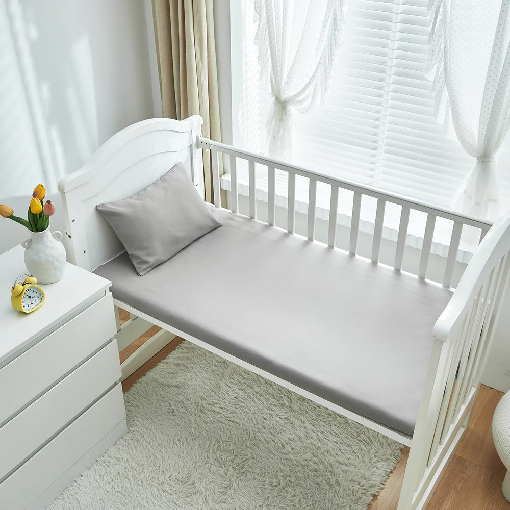 UOZZI BEDDING fitted crib sheet 28x52 showcasing secure fit