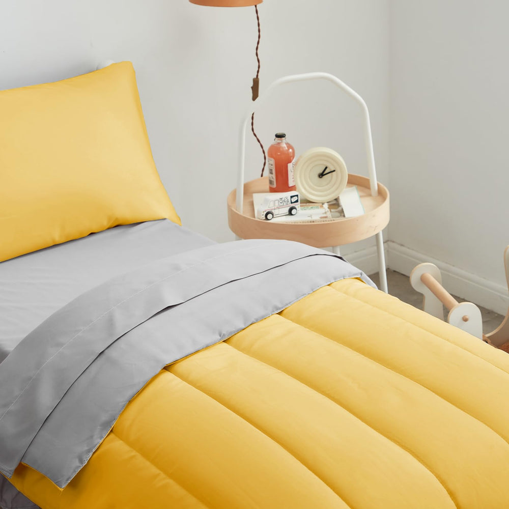 UOZZI BEDDING gray flat top sheet on a toddler bed.