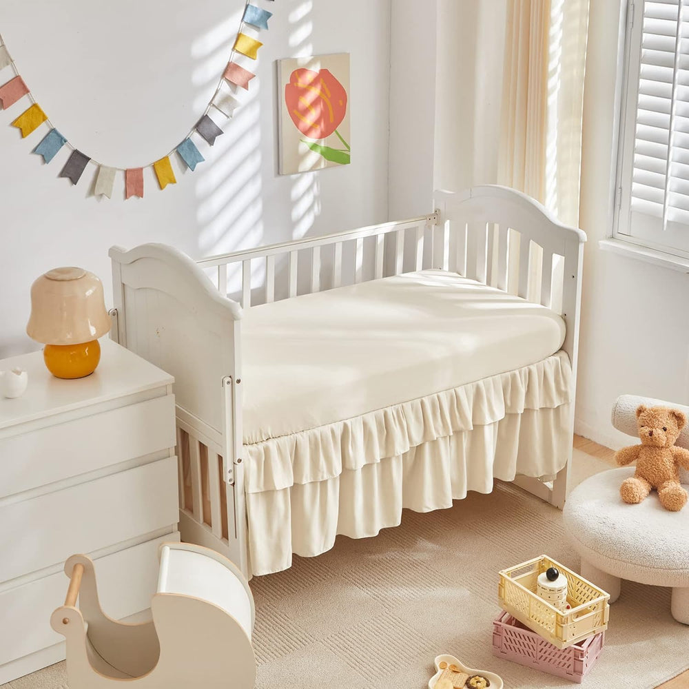 UOZZI BEDDING mini crib skirt with 14-inch ruffle adds charming finish.