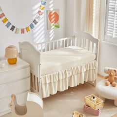 UOZZI BEDDING mini crib skirt with 14-inch ruffle adds charming finish.