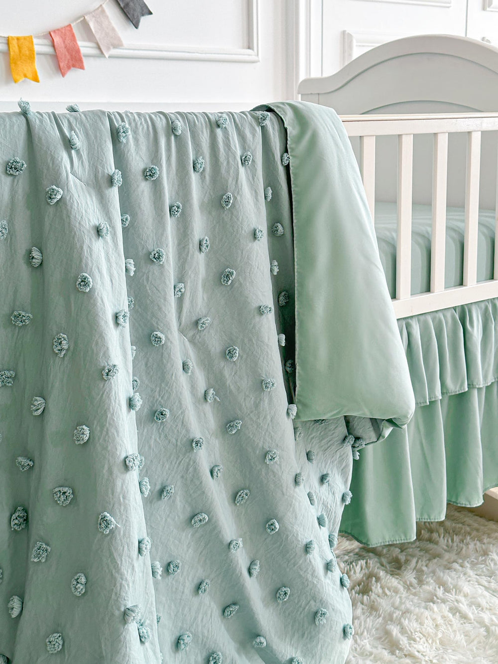 UOZZI BEDDING three-piece crib set includes comforter, sheet, and bed skirt.