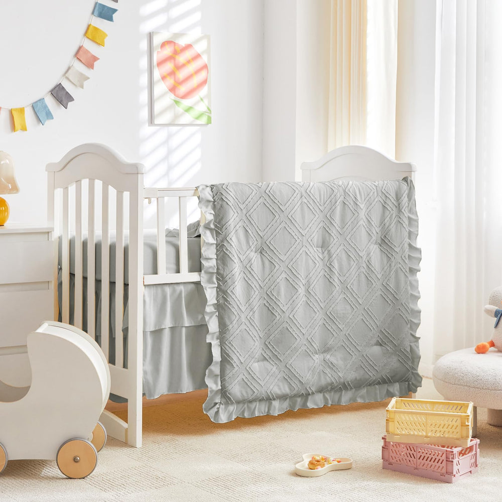UOZZI BEDDING tufted ruffle comforter closeup shows soft, cozy nursery fabric.
