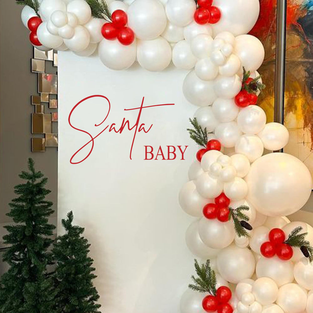 Upfirst Santa Baby decal party setup, simplifies cohesive holiday decorations for any venue