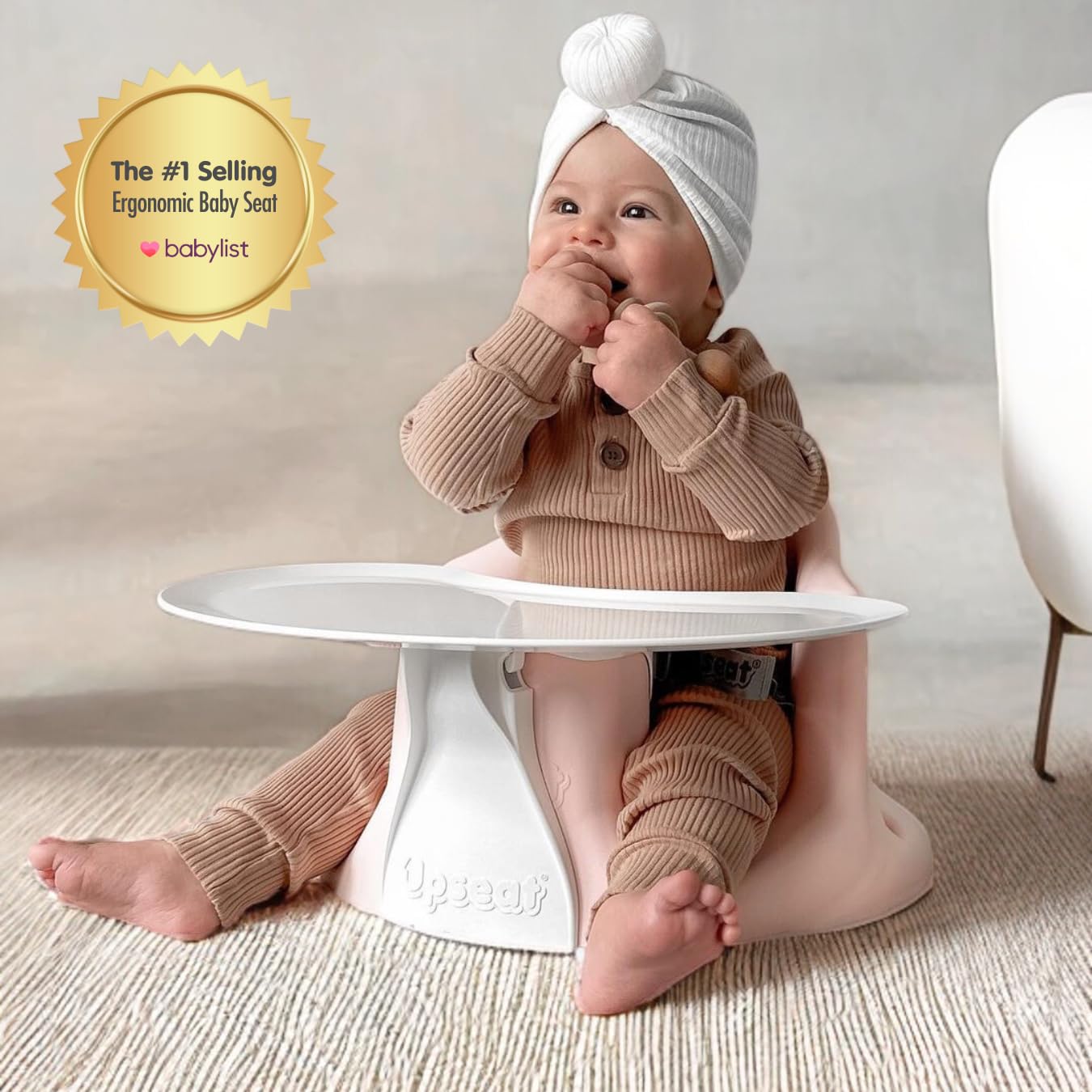 Upseat baby seat in use demonstrates transition from floor to booster seating.