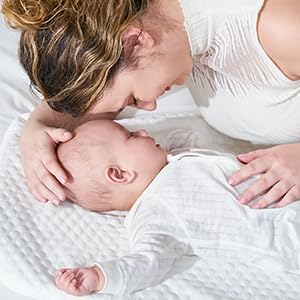 VaVaSoo bassinet positioned for easy bedside diaper changes and feeding.