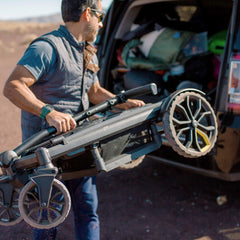 Veer All-Terrain Cruiser folded compact with wheels removed for trunk storage