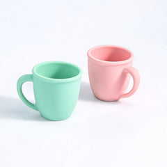 Vemolea pink-handled silicone training cup supports easy grip for tiny hands.